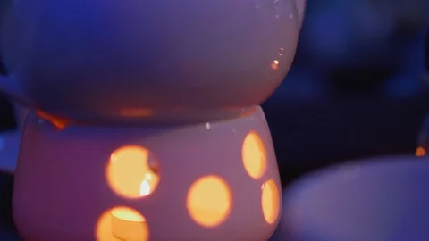 Candlelight under teapot on cafe table Stock Footage 98170791