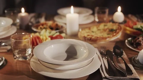 Candlelit dinner table setting with food and drinks ready for celebration. Stock Footage 334698391