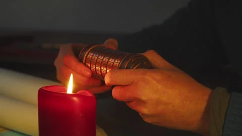 Candlelit Hands Attempting to Unlock Cryptex, Suspenseful Code Breaking Scene Stock Footage 334358746