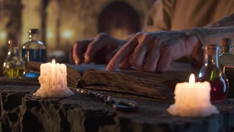 Candlelit reading of an old manuscript in a medieval setting Stock Footage 311156415