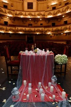 A candlelit romantic dinner set up for two within an empty vintage theater. t Stock Photos