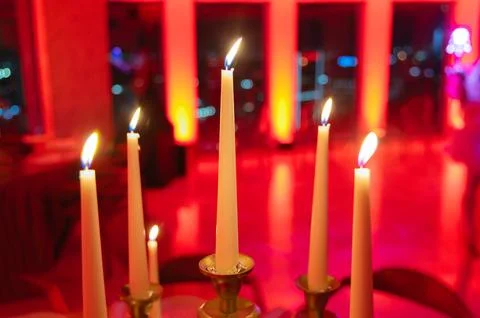 Candlelit Table with Red Lighting in Elegant Setting Stock Photos