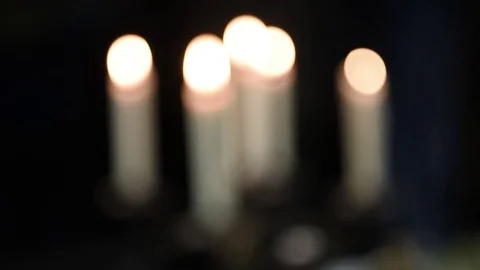 Candles are burning on a table in a candlestick Stock Footage 71185841