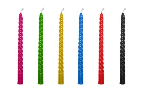 Candles are multi-colored isolated on a white background. Stock Photos