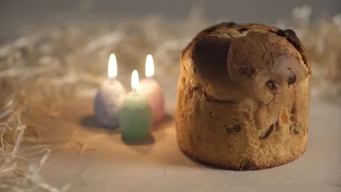 Candles around Easter Pie on a wooden table Stock Footage 87511714
