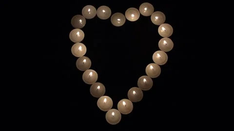 Candles arranged in a heart shape and then blown out Stock Footage 60355662