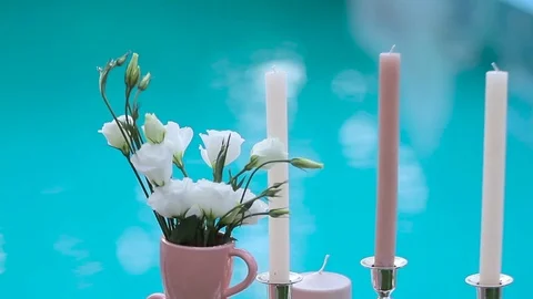 Candles on the background of blue water Stock Footage 74457557