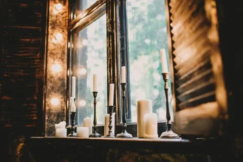 Candles on a beautiful window Stock Photos