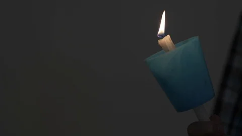 Candles being lit during a wake Stock Footage 89974498
