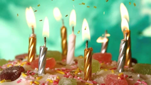 Candles on a birthday cake and confetti Stock Footage