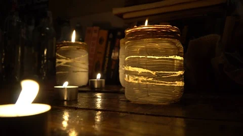 Candles burn on the atmospheric background 4k Stock Footage