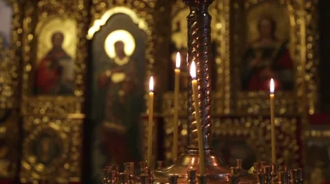 Candles burn on a background an iconostasis. Video stock 67471655