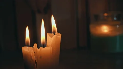 Candles Burn in Dark Against Background of a Shelf with Old Books Stock Footage 229543829