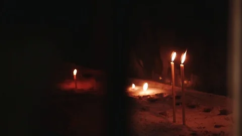Candles burn on a dark background, temple, monastery Stock Footage 124265204