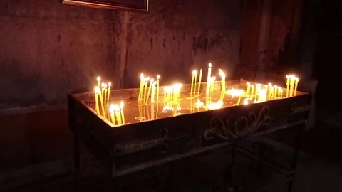 Candles burn in a dark building Stock Footage