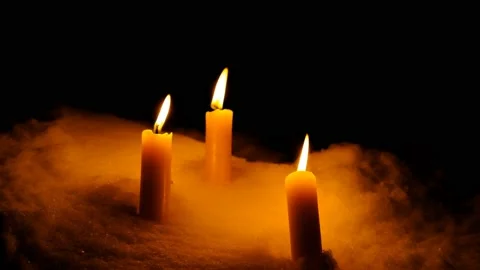 Candles burn in the snow on a dark background at the end of the candle go out Stock Footage 102106488