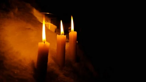 Candles burn in the snow for your Various Religious, Romantic and Meditative Stock Footage 102102760
