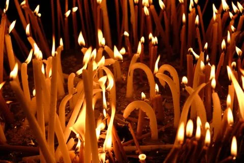 Candles burn in the temple Stock Photos