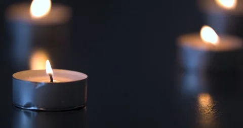 Candles Burning on a Black Table Stock Footage 101371290