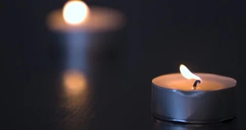 Candles Burning on a Black Table Stock Footage 101371689