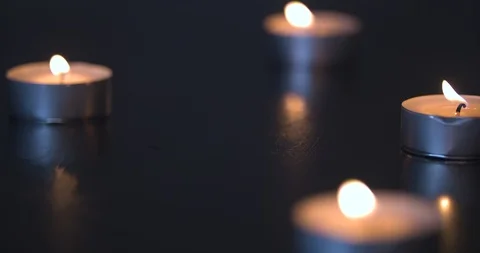 Candles Burning on a Black Table Stock Footage 101372126