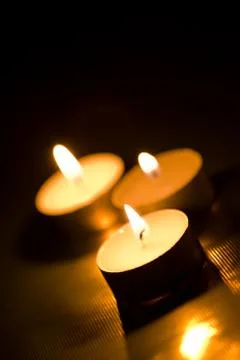 Candles burning in the dark Stock Photos