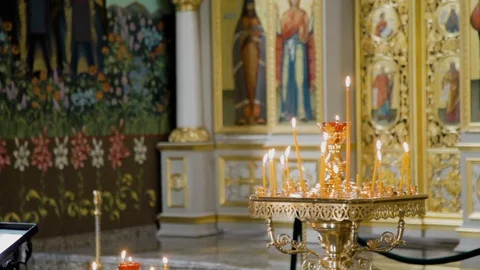 Candles burning inside Pyatigorsk Eastern Orthodox catherdral in Russia Stock Footage 122444678