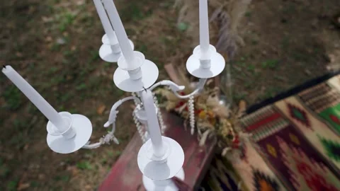 Candles in candle holder, flasks on carpet near bohemian tipi arch decorated. Stock Footage 204928751