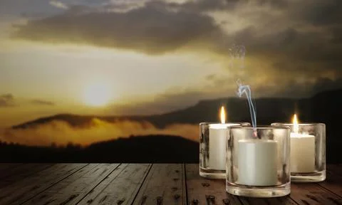 Candles in clear glass, placed on a table, wooden surface. In the evening, .. Stock Photos