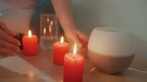 Candles create ambiance. Illuminated candles set tranquil mood in comfortable Stock Footage 329891782