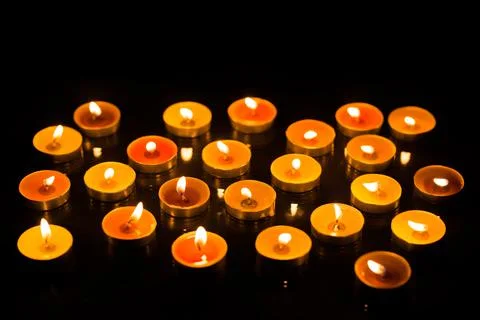 Candles in the dark with reflection and shallow depth of field Stock Photos