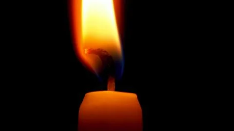 The candle's on fire, close-up. Stock Photos