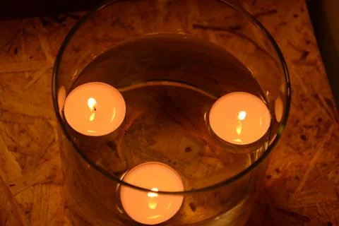 Candles float above the water 스톡 사진