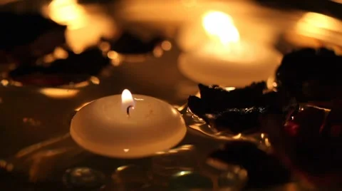 Candles floating in water Stock Footage 7749069