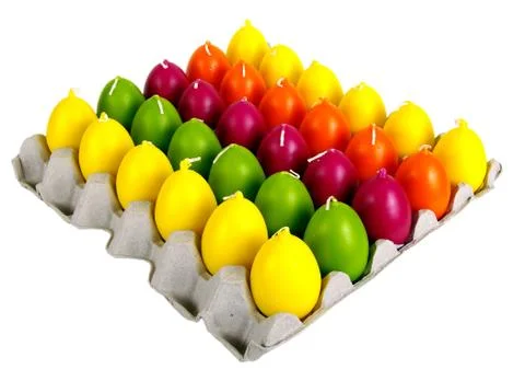 Candles in the form of easter eggs. Beautiful ornaments by a holiday. Stock Photos