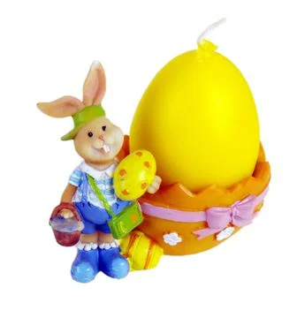 Candles in the form of easter eggs. Beautiful ornaments by a holiday. Stock Photos