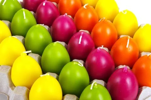 Candles in the form of easter eggs. Beautiful ornaments by a holiday. Stock Photos