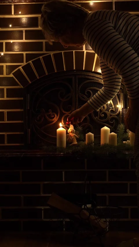 Candles glowing warmly on a fireplace Stock Footage 292280192