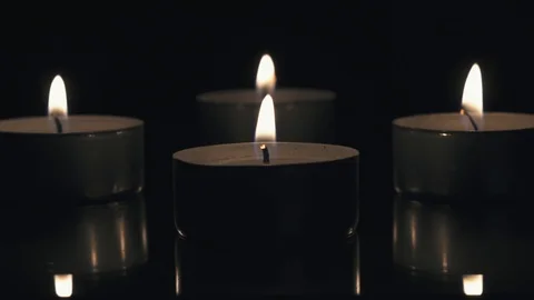 Candles, grouped together on dark background Stock Footage 95488841