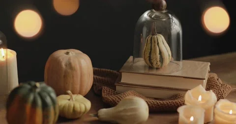 Candles on Halloween table with pumpkins and books in a dining room Stock Footage 140822895