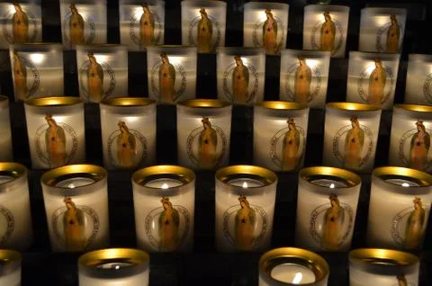 Candles with the image of the saint Maria inside the Notre Dame de Paris famous Stock Photos