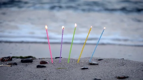 Candles inserted into the sand on a sandy beach on the sea ocean shore Stock-Footage 140699588