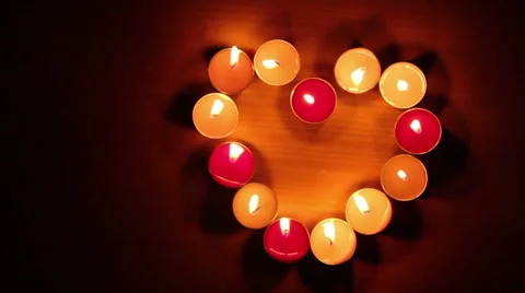 Candles light in heart shape, black background. Stock Footage 54209843