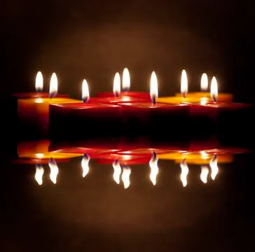 Candles lighting in the darkness Stock Photos