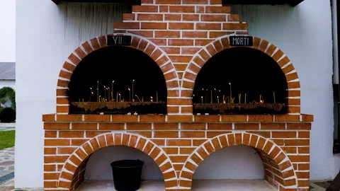 Candles lit in memory of the dead at an altar in the church. Stock Footage 258355812