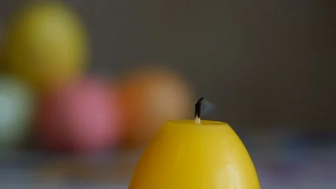 Candles made in shape of easter egg. Burning candles. Yellow candles Stock Footage 106147841
