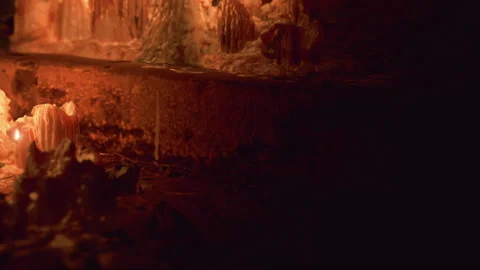 Candles melt on the ground during a nighttime outdoor gathering Stock Footage 339503992