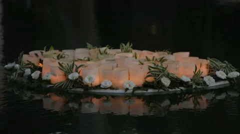 Candles in nuthells floating on water Stock Footage 66443437