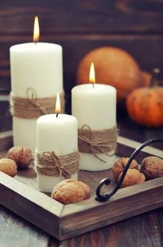 Candles with nuts and pumpkin Stock Photos