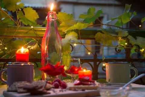Candles on romantic table at late evening Stock Photos